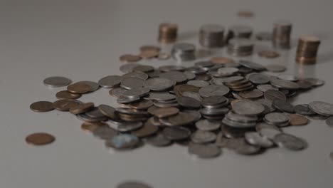 focusing in on various coins in a pile