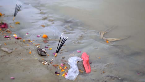 an incense stick is lit on the side of river