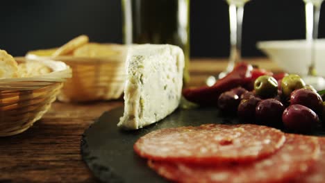 cheese, olive and salami on table