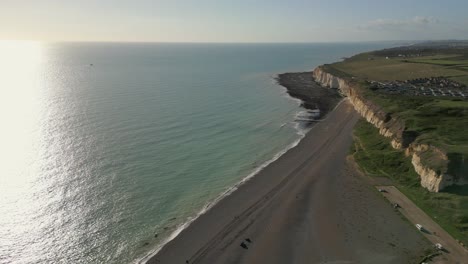 newhaven shore line with sun and cliffs , pebbles beach