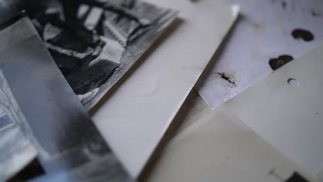 a close up macro shot of old, black and white portrait photographs of people from the 80s, laid out on a table together.