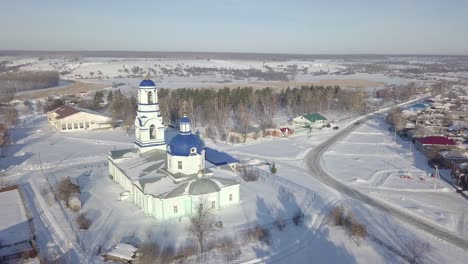 aerial view of a church in a snowy russian village