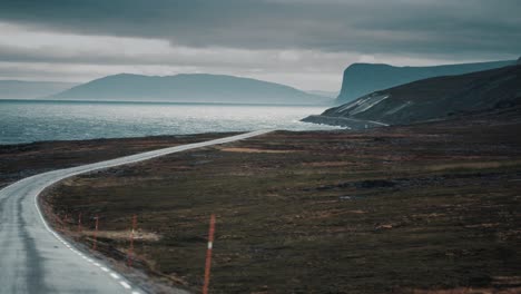 the narrow coastal road winding along the fjord