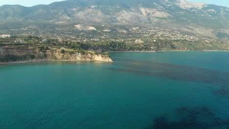 aerial flying towards mesmerizing isolated house on cliff edge, greek island landscape