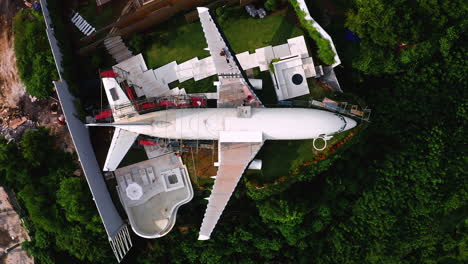 private jet plane being repaired in crammed garden in jungle in bali