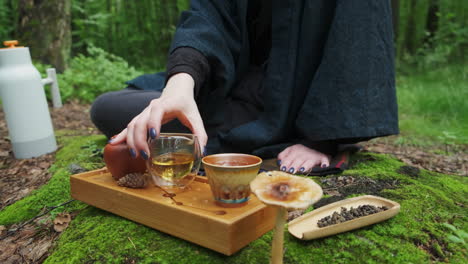 woman enjoying a tea ceremony in the forest