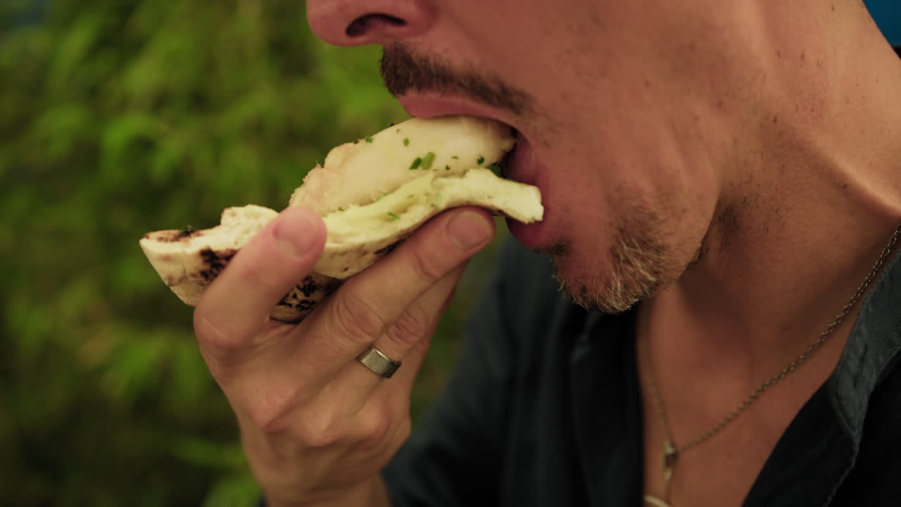 Man Giving A Bite To A Slice Of Pizza With Octopus At The Beach Resort