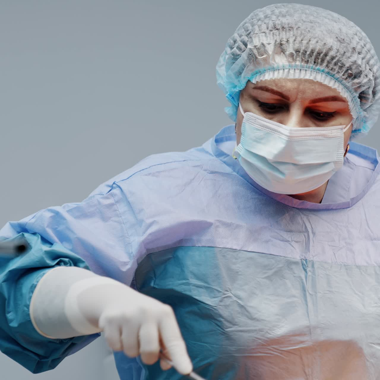 Female doctor covers the big pregnant patient's belly with iodine solution. Preparation for C-section surgery