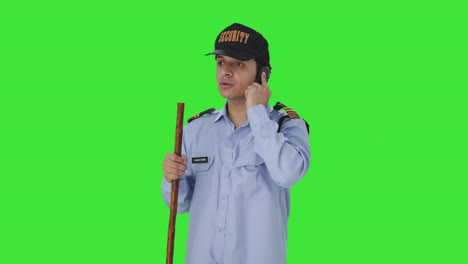 Indian-security-guard-talking-on-phone-Green-screen