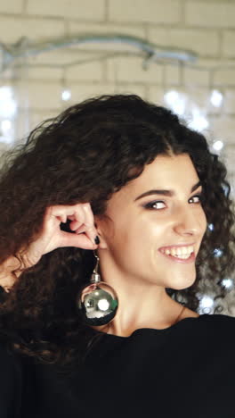 woman with christmas toy. young woman with toy for christmas tree vertical video