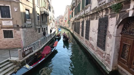 gondola navigating narrow canal in venice, italy