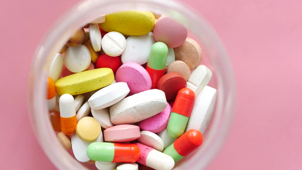 Assorted Colorful Pills in a Clear Jar