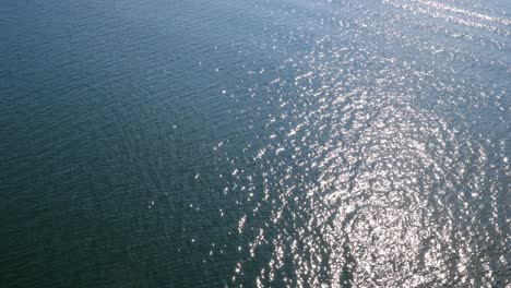 4k video of ripples and sun glare on water surface