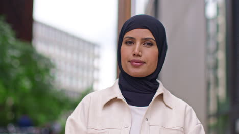 Close-Up-Portrait-Of-Smiling-Muslim-Businesswoman-Wearing-Hijab-With-Business-Suit-Outside-Modern-Office-Buildings-1