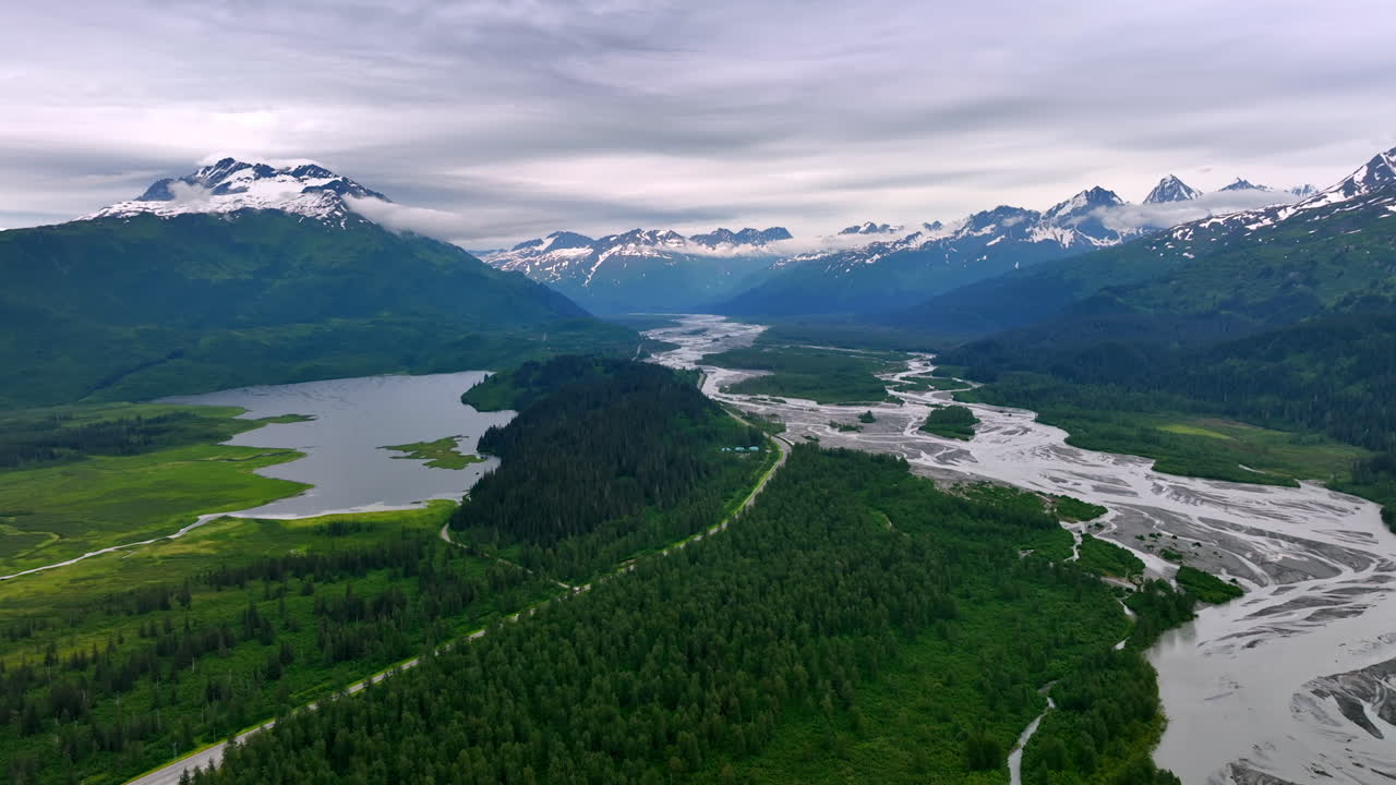 Discover Alaska pristine beauty. Experience the breathtaking vistas of Alaska, featuring majestic mountains, winding rivers, and lush greenery