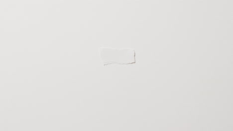 video of close up of torn piece of paper with copy space on white background
