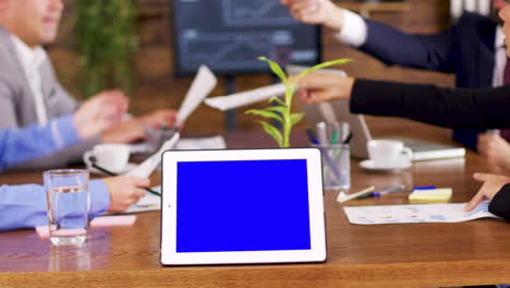 tablet with blue screen on the table in the conference room