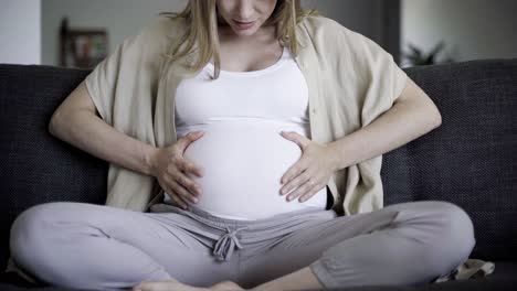 Beautiful-married-pregnant-woman-rubbing-belly-and-talking