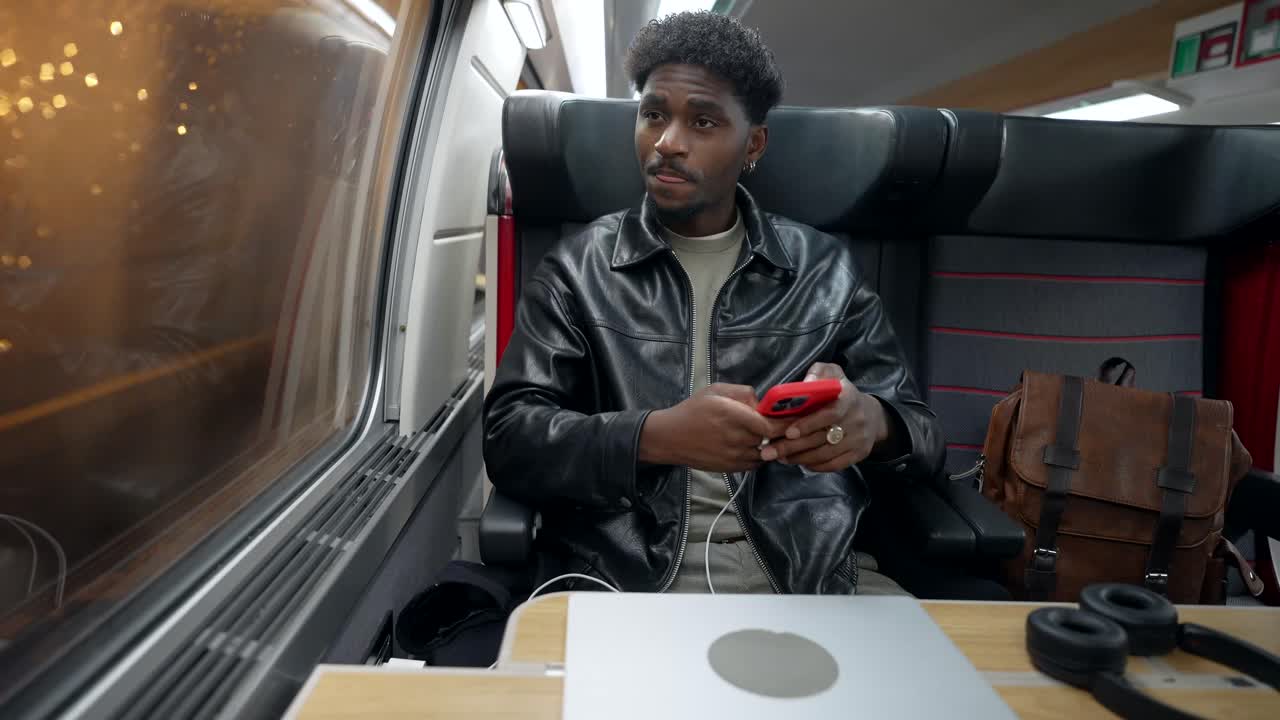 Man using mobile phone on a train