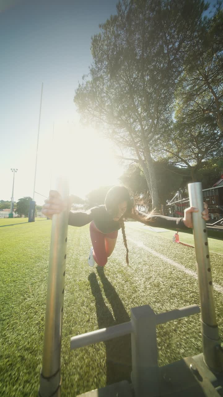 Woman doing sled push exercise outdoors