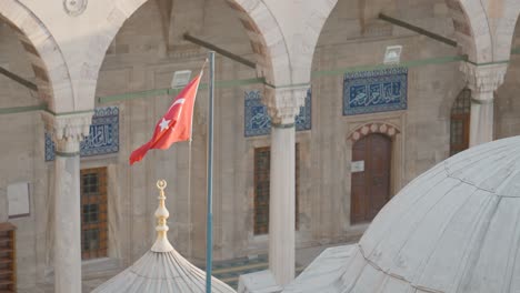 turkish flag flying over a historic mosque