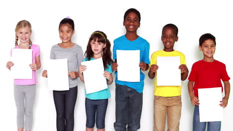 cute little children covering face with white paper