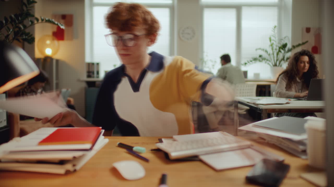 Time Lapse of Young Man Handling Paperwork and Using Computer in Office