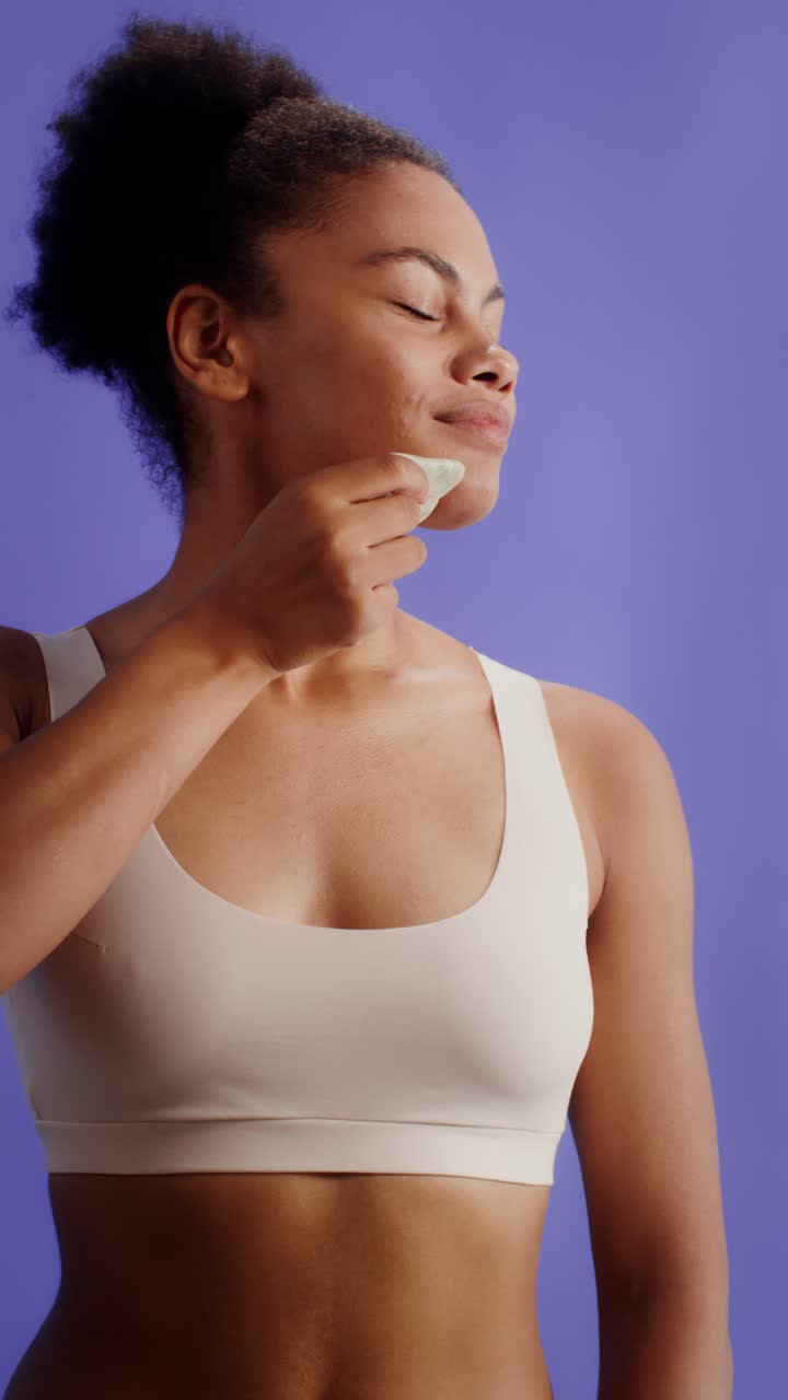 Woman performing skincare with gua sha