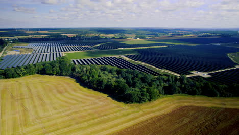 vista of countryside farmland with huge solar panel field on sunny day