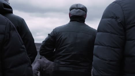 people watching an event in cloudy weather