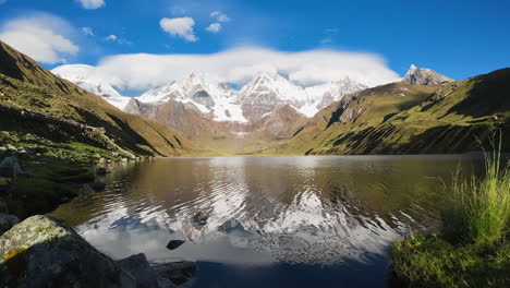 time lapse: clouds drift over cordillera blanca peaks from lake shore
