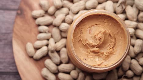 peanut butter in a jar with peanuts