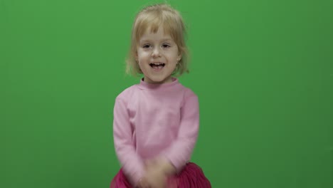 Happy-three-years-old-girl.-Cute-blonde-child.-Dancing-and-make-faces