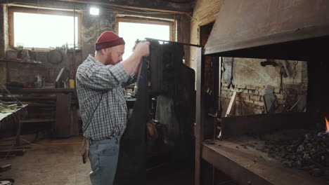 Blacksmith-Preparing-Fire-in-Forge-before-Work