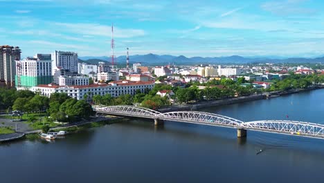 aerial dolly over the truong tien bridge and perfume river showing downtown hue