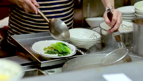 chef prepares noodle soup with vegetables and broth