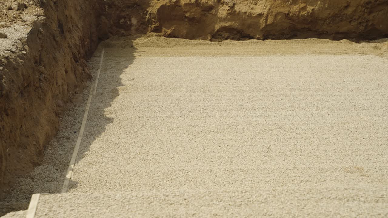 Flat gravel layer finished in trench for residential pool build in Wisconsin
