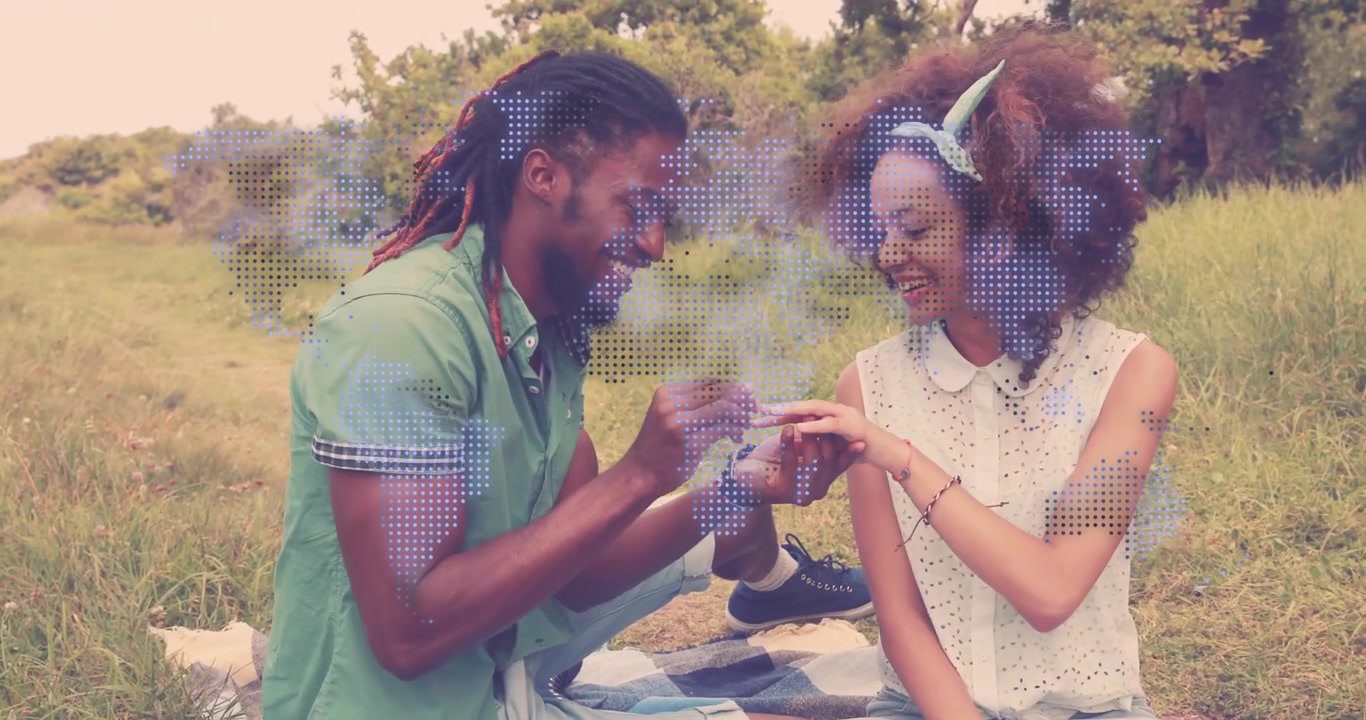 Man covering woman's eyes, revealing ring box, kneeling and sliding ring onto her hand for wedding