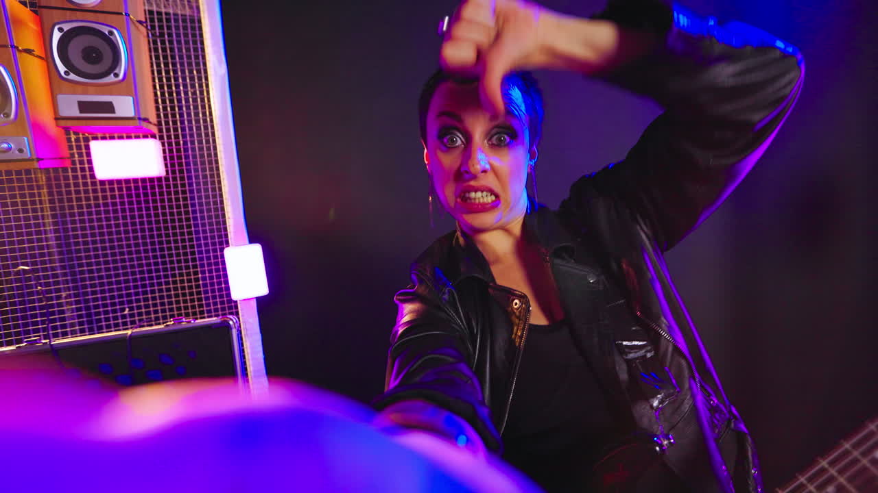 Woman in Leather Jacket Performing on Stage