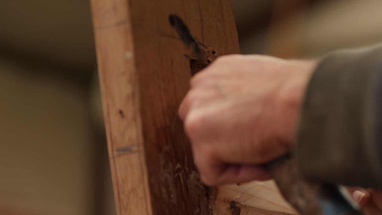 Shipwright cleaning out boat stem for next plank