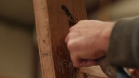 shipwright cleaning out boat stem for next plank