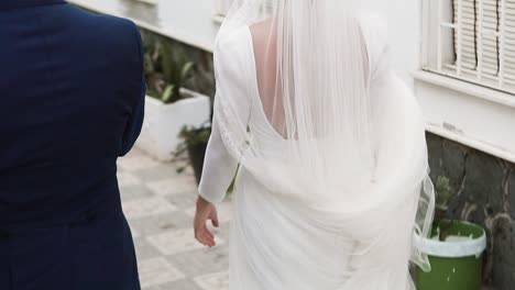 woman dressed as a bride on her wedding day from behind