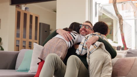 father embracing his children on the couch