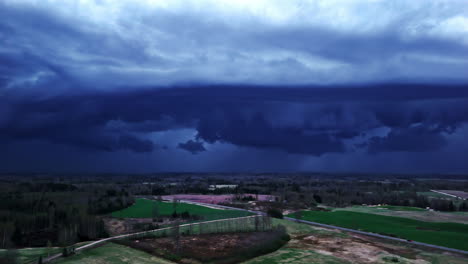 drone footage of a landscape under dark, threatening storm clouds.