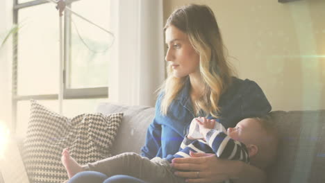 animation of glowing spots over caucasian mother with baby with drinking milk