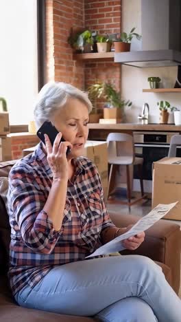 a woman is talking on her cell phone while sitting on a couch