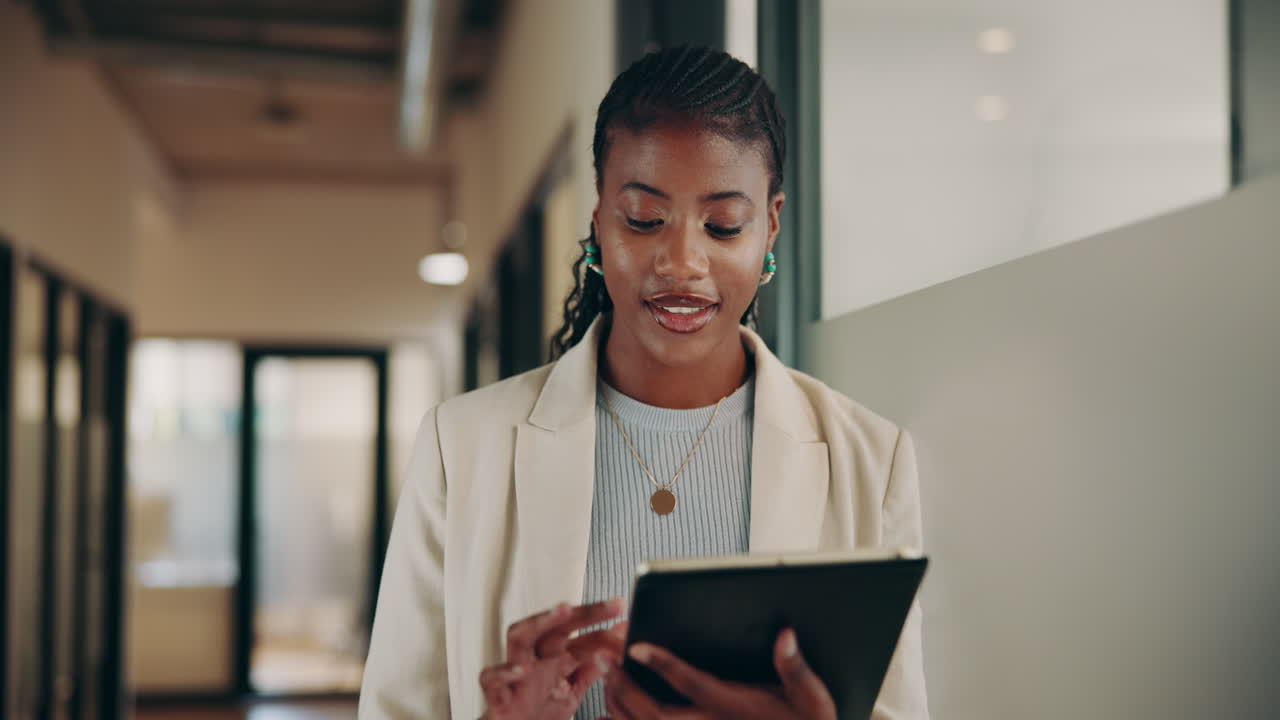 Smiling Businesswoman Using a Tablet in the Office