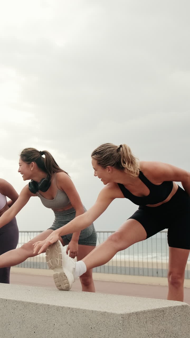 Happy Female Friends Stretching by the Sea