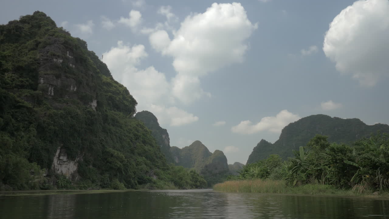 Scenic landscape of river and green mountains in Trang An Vietnam