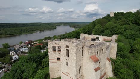 ruins of a romanesque castle complex with viewing terraces and an observation tower